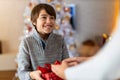 Smiling boy receiving gift at Christmas