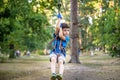 Smiling boy rides a zip line. happy child on the zip line. The kid passes the rope obstacle course