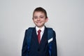Smiling boy in school uniform and backpack on white background. Junior High School concept. half-length portrait Royalty Free Stock Photo