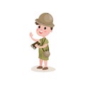 Smiling cartoon boy scout character standing with binoculars in hand