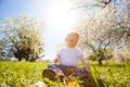 Smiling boy sits on a grass under sun beams Royalty Free Stock Photo
