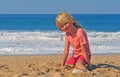 Smiling boy sitting on the beach Royalty Free Stock Photo
