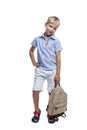 A smiling boy stands with a backpack in his hand. Back to school. Vertical. Isolated on a white background Royalty Free Stock Photo