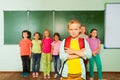 Smiling boy stands in front near blackboard Royalty Free Stock Photo