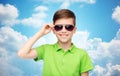 Smiling boy in sunglasses and green polo t-shirt Royalty Free Stock Photo