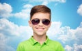 Smiling boy in sunglasses and green polo t-shirt Royalty Free Stock Photo