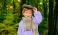 Smiling boy in sweater, hat and scarf. Little kid in Autumn park. Cute child in warm clothes. Royalty Free Stock Photo