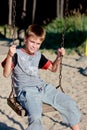 Smiling boy on the swing