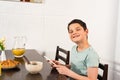 Boy using digital tablet during breakfast in kitchen Royalty Free Stock Photo