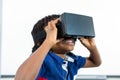 Smiling boy using virtual reality headset in classroom Royalty Free Stock Photo