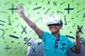 Composite image of smiling boy using virtual reality simulator