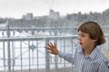 Smiling boy watching the rain outside at a window Royalty Free Stock Photo