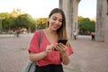 Smiling Brazilian girl using smartphone in Porto Alegre, Rio Grande do Sul, Brazil