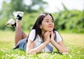 Smiling brazilian teenager while lying in summer green park