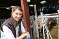 Smiling breeder woman in barn Royalty Free Stock Photo