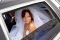Smiling bride with groom in wedding limo Royalty Free Stock Photo