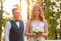 Smiling Bride Holding Bridal Bouquet Near Groom After Making a Vow And Smiling. Wedding Outdoors in Summer Park Royalty Free Stock Photo