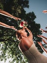 Smiling bride throws the wedding bouquet of her friends Royalty Free Stock Photo