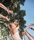 Smiling bride tossing a bouquet for her good friends Royalty Free Stock Photo