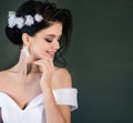 Smiling bride with wedding makeup and fashion hairstyle. Gorgeous young woman in a white dress with jewelry in her hair Royalty Free Stock Photo