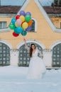 Smiling bride winth roses in hair and balloons in hands Royalty Free Stock Photo