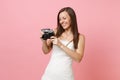 Smiling bride woman in wedding dress holding looking on retro vintage photo camera choosing staff photographer Royalty Free Stock Photo