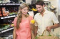 Smiling bright couple buying food products Royalty Free Stock Photo