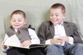 Smiling brothers reading book