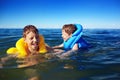 Smiling brothers swimming