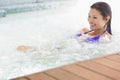 Smiling brunette in bikini relaxing in hot tub Royalty Free Stock Photo