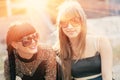 Smiling brunette and blobde women backlit by sunset Royalty Free Stock Photo