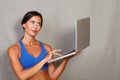 Smiling brunette female holding and using laptop Royalty Free Stock Photo