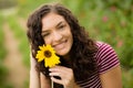 Happy teenage high school senior girl in sunflower field