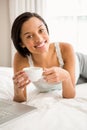 Smiling brunette holding cup Royalty Free Stock Photo