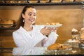 Smiling brunette selling tarts Royalty Free Stock Photo