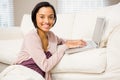 Smiling brunette using laptop Royalty Free Stock Photo