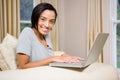 Smiling brunette using laptop Royalty Free Stock Photo