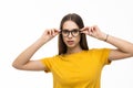 Smiling brunette woman in eyeglasses posing looking at the camera over white background Royalty Free Stock Photo