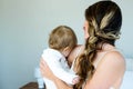 smiling brunette woman holding a baby Royalty Free Stock Photo