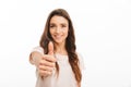 Smiling brunette woman in t-shirt showing thumb up Royalty Free Stock Photo
