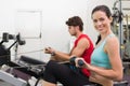 Smiling brunette working out on the rowing machine Royalty Free Stock Photo