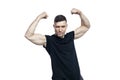 Smiling brutal man in a black T-shirt shows big muscles on his arms. Sports and active lifestyle. Isolated on a white background Royalty Free Stock Photo