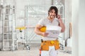 Smiling builder or architect holding a blueprint Royalty Free Stock Photo