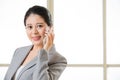 Smiling Business asain Woman Talking on a Mobile phone Royalty Free Stock Photo