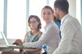 Smiling business colleagues discussing at table in new office during meeting Royalty Free Stock Photo