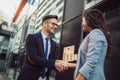 Smiling business colleagues greeting each other outdoors