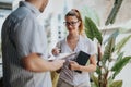 Smiling professionals having an outdoor discussion with a clipboard and notebook Royalty Free Stock Photo