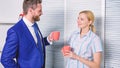 Smiling business couple at office room talking in coffee break. Business and people concept. Work culture. Royalty Free Stock Photo