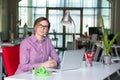 Smiling Business Lady in casual clothing sitting at Office Table Royalty Free Stock Photo