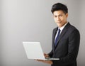 Smiling business man holding laptop Royalty Free Stock Photo